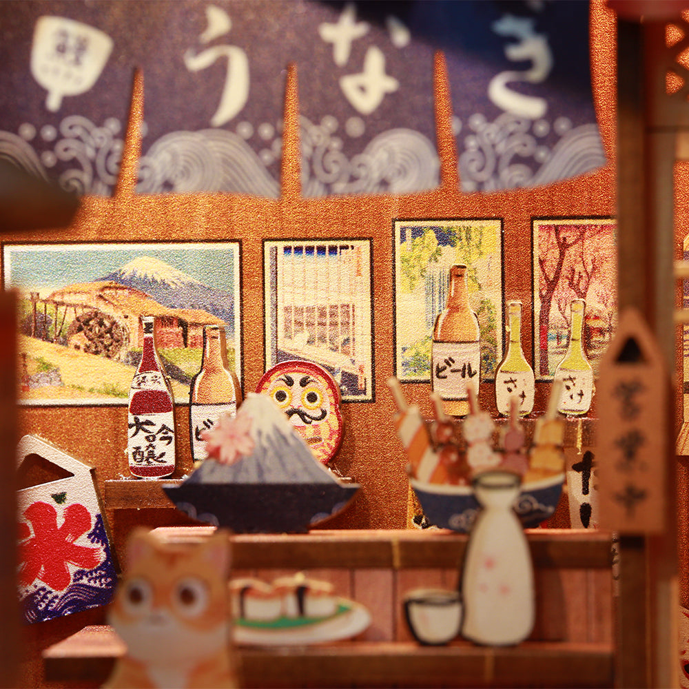 Scène de restaurant japonais miniature avec divers aliments et boissons.