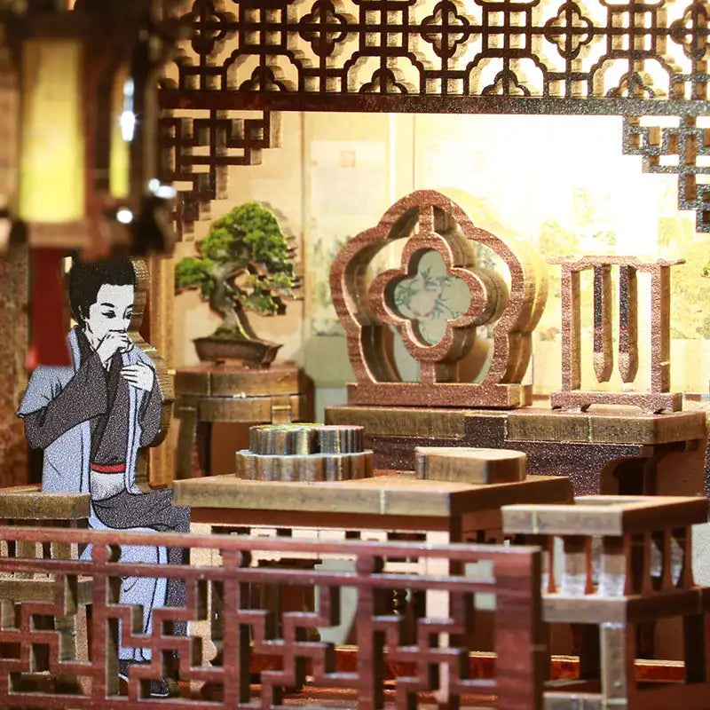 Une chambre miniature de style traditionnel de l’Asie de l’Est avec un personnage.