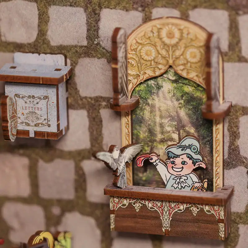 Diorama miniature représentant une fenêtre avec une scène de forêt et un personnage, ainsi qu’une boîte aux lettres.