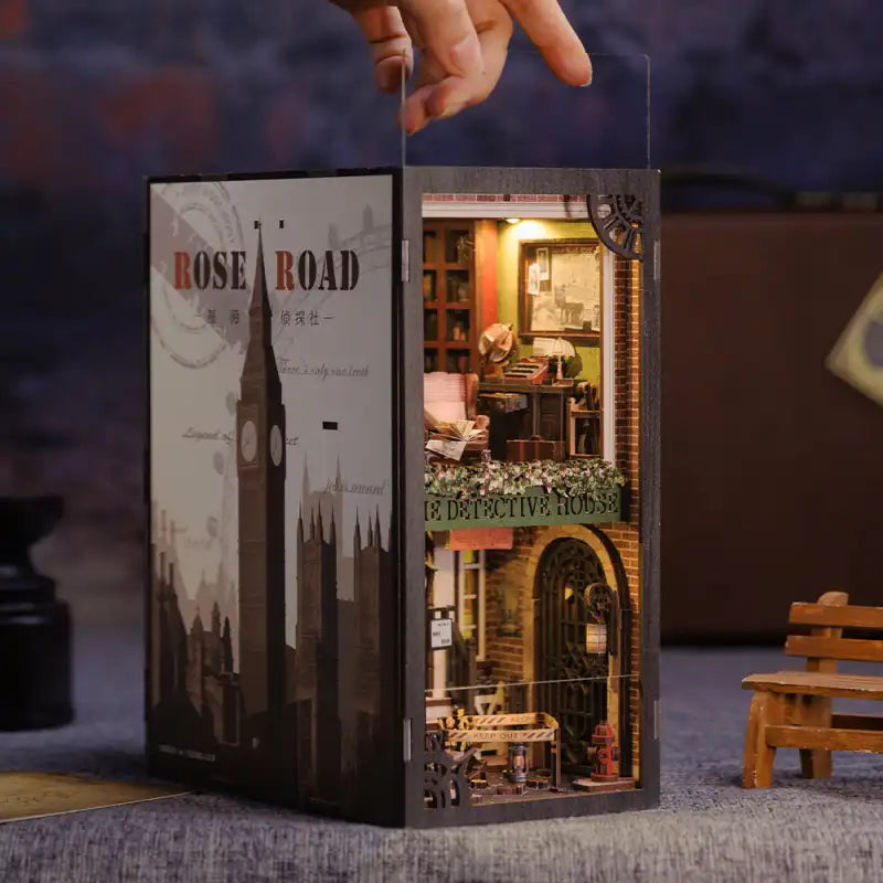Diorama de livre miniature avec un paysage urbain londonien sur la couverture et un intérieur à plusieurs étages sur le thème du détective.