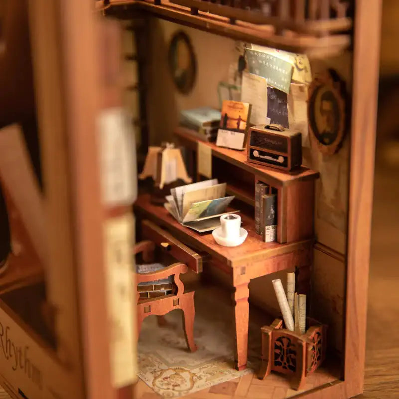 Diorama miniature en bois d’une salle d’étude avec un bureau, une chaise et divers petits accessoires.