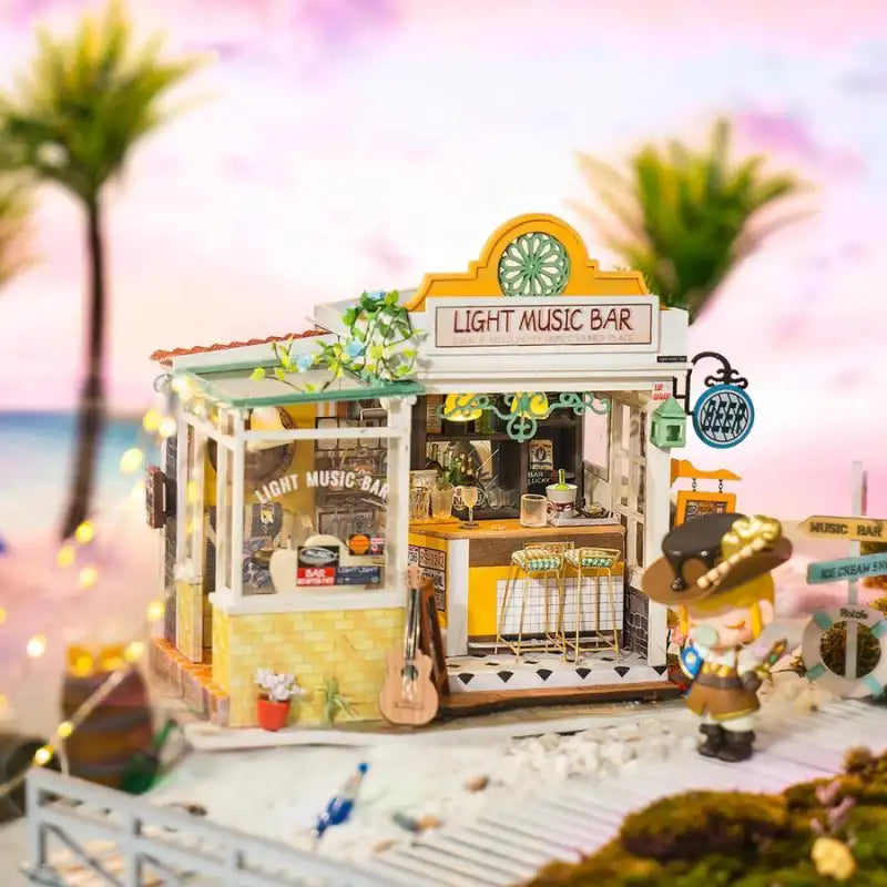 Jeu miniature de bar à musique sur le thème de la plage avec des meubles et des accessoires détaillés.