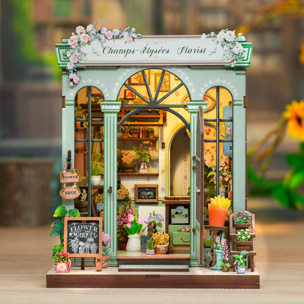 Un magasin de fleurs miniature de maison de poupée verte avec des détails complexes.
